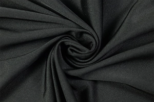 Macro view of premium black fabric folds showing sleek drape and elegant texture