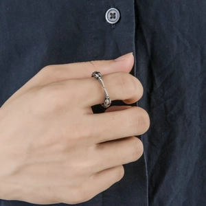Detailed macro view of vintage punk eagle beak ring with skeletal bone texture on finger