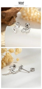 Macro view of silver swan earrings with cubic zirconia and flat screw back posts
