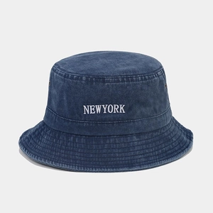 Close-up of New York embroidery and metal eyelets on navy washed cotton bucket hat