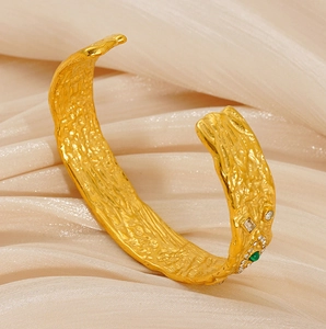Detail of vintage textured gold bangle featuring green malachite and sparkling zircons