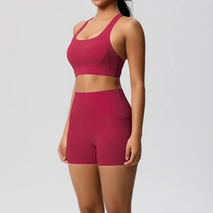 Detail of rose red yoga shorts featuring a functional side pocket and high waist fit