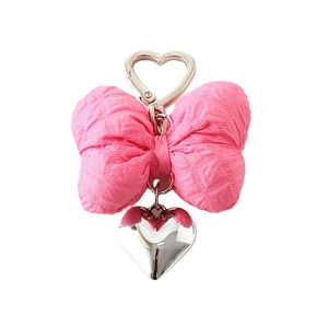 Pink quilted bow keychain with silver heart-shaped clasp and polished metal heart pendant