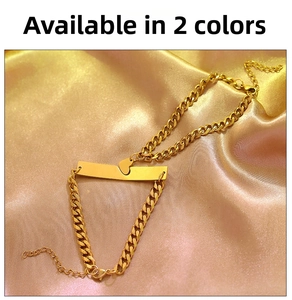 Detail of interlocking heart pendants on gold-plated stainless steel cuban chain bracelet