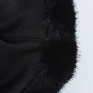 Detailed view of the black fabric and faux fur trim texture on the bodycon mini dress