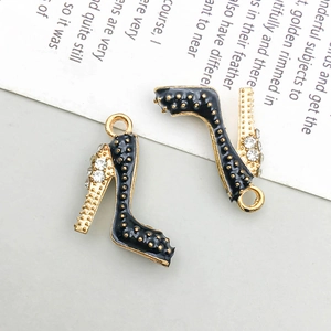 Detail of black enamel high heel pendants with gold trim and sparkling rhinestones