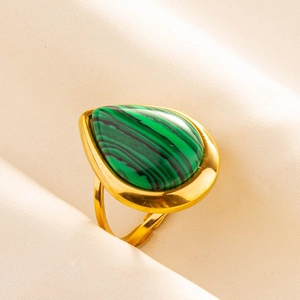 Detailed macro view of an adjustable gold ring featuring a teardrop green malachite stone