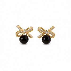 Elegant gold bow earrings with shimmering zircon and hanging smooth black tiger eye beads