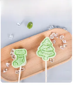 Close-up of Christmas tree and stocking shaped popsicles in a light wooden tray
