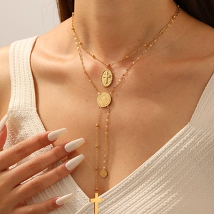 Layered gold stainless steel necklace with cross and portrait relief coin pendants