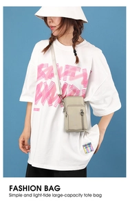 Beige multi-layer mini crossbody phone bag shown on a model with a heart-shaped zipper