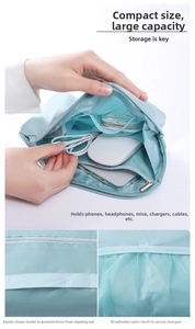 Detail view of light blue travel tech pouch with elastic straps and mesh pockets for cables