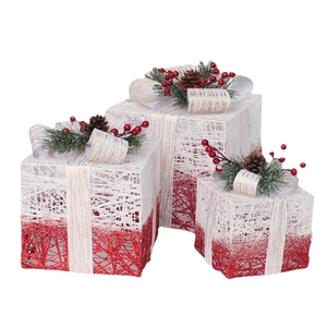 Three-piece glowing Christmas gift box set with pine needles and red berries