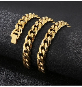 Detailed close-up of 10mm golden stainless steel Cuban chain bracelet with push buckle