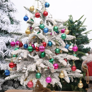 Set of 12 colorful textured Christmas ball ornaments on a snowy white tree