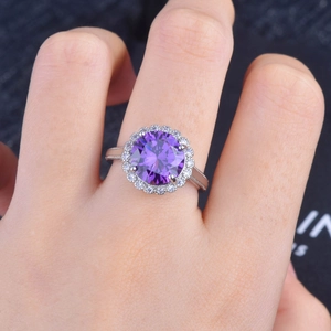 Elegant 5-carat purple gemstone ring with halo diamonds on a silver vintage band