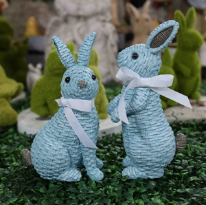 Pair of light blue resin rabbits with woven texture and white bows for garden decor