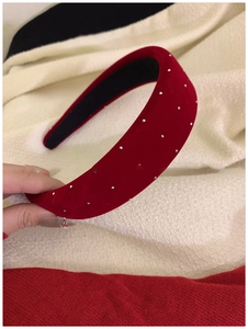 Close-up of red velvet headband with sparkling silver rhinestones for elegant hair styling