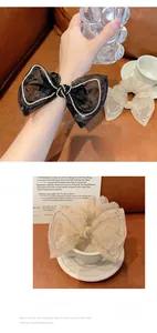 Detail of sheer mesh bow scrunchies with sparkling rhinestone edges in black and beige