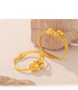 Detailed close-up of multilayer gold-plated steel bracelet with PVD electroplating