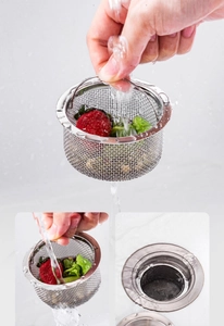 Close-up of stainless steel kitchen sink strainer with handle showing fine mesh texture