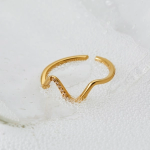 Minimalist wavy 316 stainless steel ring in gold finish with micro-inlaid zircon details
