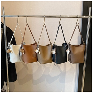 Detailed view of five colorful PU leather bucket bags with baseball glove charms