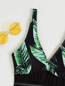 Detail of leaf print swimsuit with deep V-neckline and high elasticity quick-dry fabric