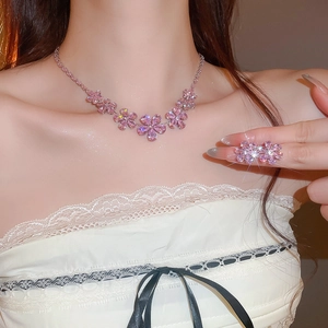 Close-up of elegant pink zircon flower pendant necklace worn by a fashion model