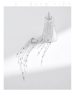 Close-up of S925 sterling silver long tassel earrings on a white jewelry stand