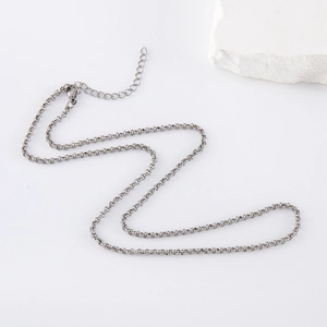 Classic silver stainless steel pearl necklace with O-chain and lobster clasp on white stone
