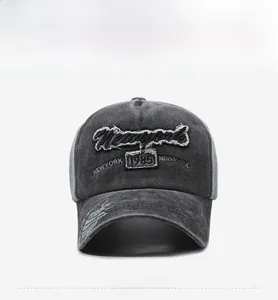 Detail of vintage washed baseball cap featuring Newyork 1985 embroidery and curved brim