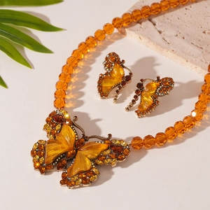 Amber beaded necklace with crystal butterfly pendant and matching stud earrings set