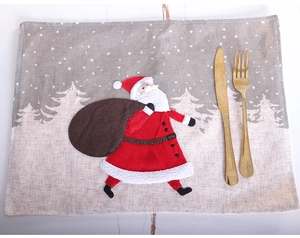 Linen Christmas placemat with Santa Claus embroidery and golden cutlery set display