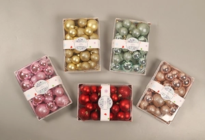 Detail of Christmas ball sets in gold, red, and green with matte and glitter finishes