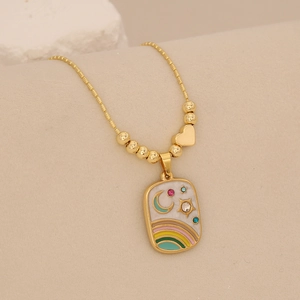 Detail of gold necklace featuring rainbow star and moon enamel pendant with inset gems