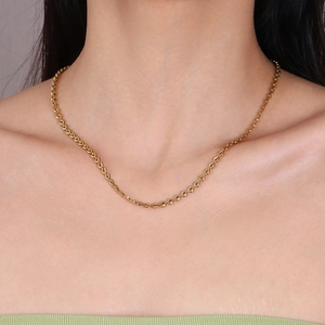 Gold stainless steel heart link necklace for women shown on a fashion model's neck