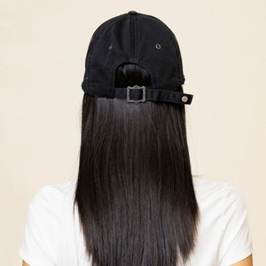 Rear view of distressed black cotton baseball cap with intricate cross design metal buckle
