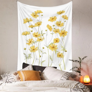Detail of bohemian floral tapestry featuring yellow cosmos flowers on a white fabric background