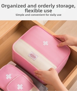 Pink and beige first aid pouch stored neatly in a wooden drawer for home organization