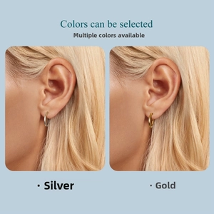 Minimalist gold and silver hoop earrings shown on a model for scale and fit