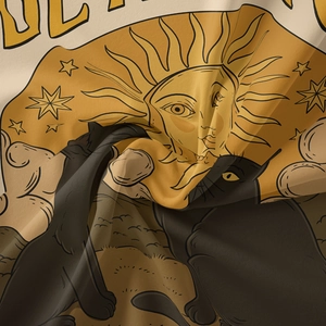 Close-up of bohemian tapestry showing black cat tarot print on soft fabric texture