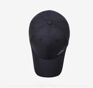 Detailed close-up of charcoal baseball cap with mountain logo and textured fabric