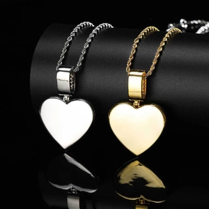Detailed view of gold and silver heart locket pendants with cubic zirconia on twist chains