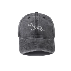 Detailed close-up of charcoal grey washed cotton cap with dachshund and love embroidery