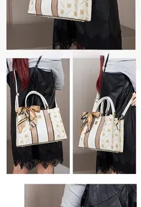 Dettaglio borsa in pelle color crema con logo del marchio e sciarpa in seta elegante