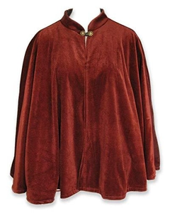 Close-up of velvet Christmas capelet featuring a decorative golden metal clasp closure