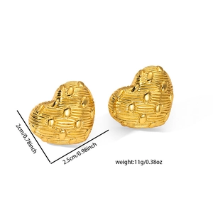 Detailed view of gold heart earrings with textured finish and measurement specifications