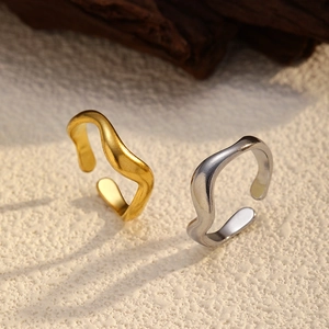 Minimalist wave open rings in 18K gold and silver plating on textured stone
