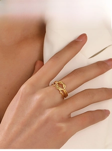Detailed view of an 18K gold-plated double-layer twisted knot ring on a model hand